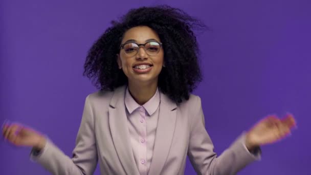 шокована афроамериканська бізнес-леді з простягнутими руками ізольована на фіолетовому
  - Кадри, відео