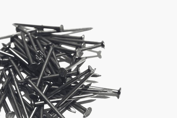 A closeup shot of metal nails on a white surface - Φωτογραφία, εικόνα