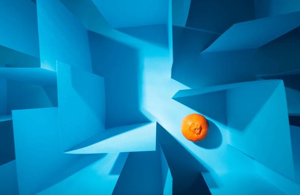  Tangerine in paper labyrinth. Concept of theme of bureaucracy.  - Photo, Image