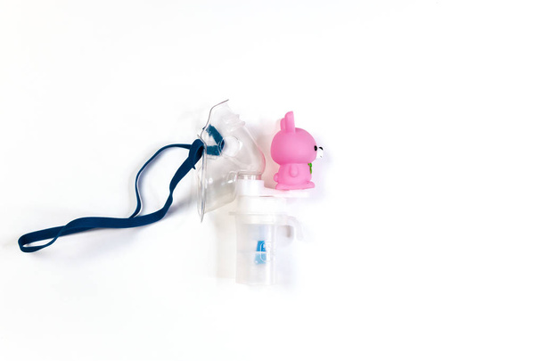 tube mask nebulizer and tubular transparent cable on white background, inhalation for children - Fotoğraf, Görsel