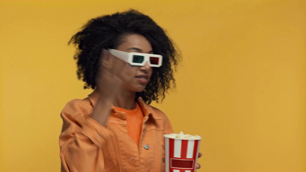 sorridente afro-americana assistindo filme isolado no amarelo
 - Filmagem, Vídeo