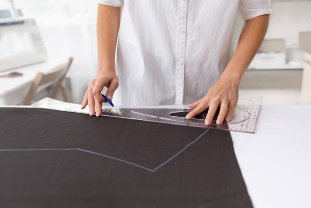 Young female dressmaker making a pattern - Фото, зображення