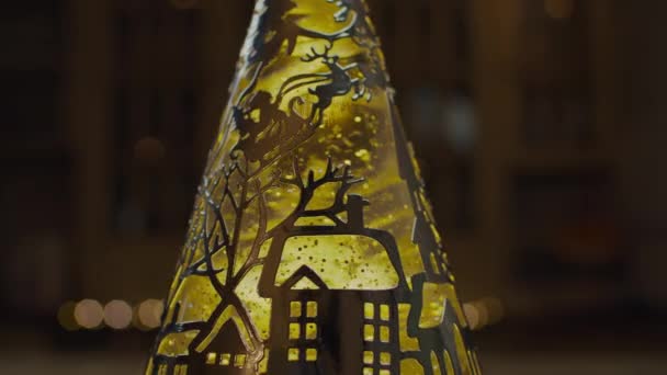 Rotating lava lamp with Christmas plot decoration in slow motion. Yellow light cone lamp.  - Filmati, video