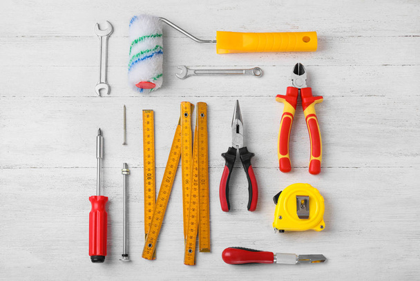 Flat lay composition with different construction tools on white  - Фото, изображение