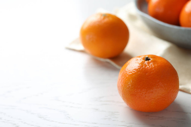Fresh ripe tangerine on white wooden table, space for text - Φωτογραφία, εικόνα