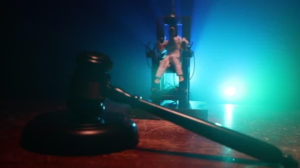 Death penalty electric chair miniature on dark. Creative artwork decoration. Image of an electric chair scale model on a dark backgorund - Footage, Video