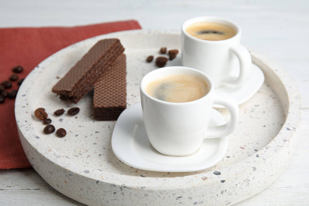 Delicious coffee and wafers for breakfast on white wooden table - Foto, imagen