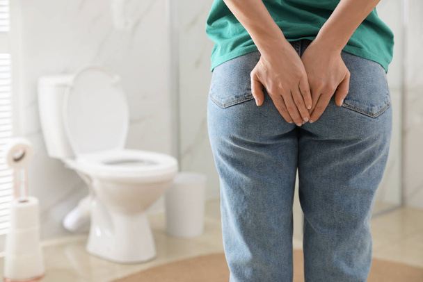 Woman suffering from hemorrhoid in rest room, closeup - Foto, Bild