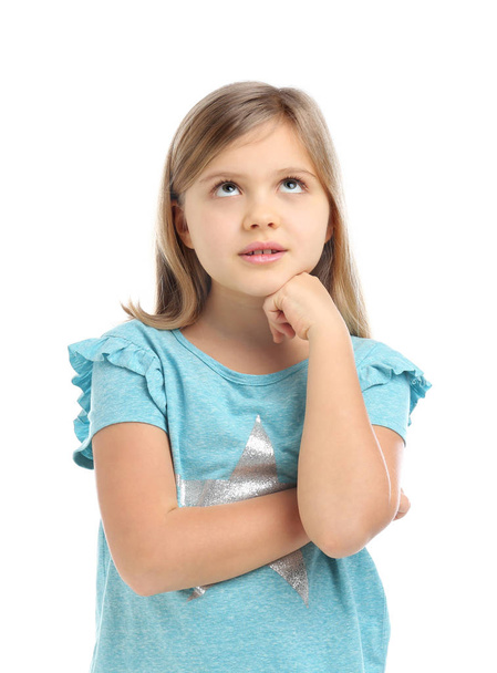 Thoughtful little girl wearing casual outfit on white background - Foto, Imagen
