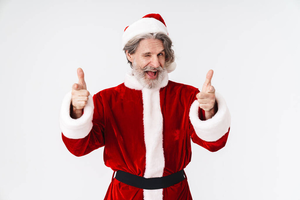 Image of Santa Claus old man in red costume pointing fingers at  - Foto, Imagem