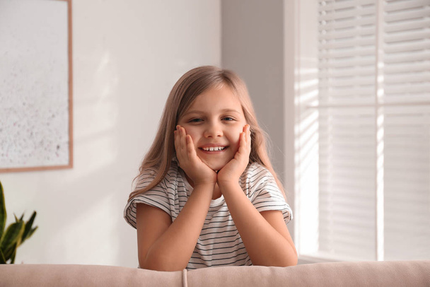 Cute little girl on couch at home - Foto, immagini