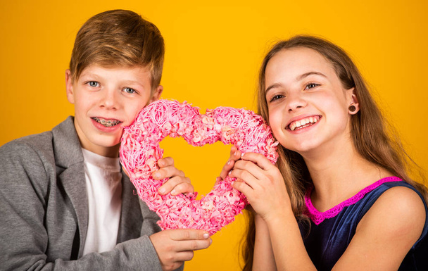 Come live in my heart. Happy children hold pink heart yellow background. Gift for Valentines Day. Gift shop. Shopping for gift. Love and friendship. Only gift I can give you is my heart - Φωτογραφία, εικόνα