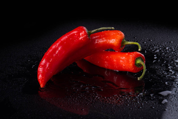 Three cayenne peppers in quaint form. - Photo, Image