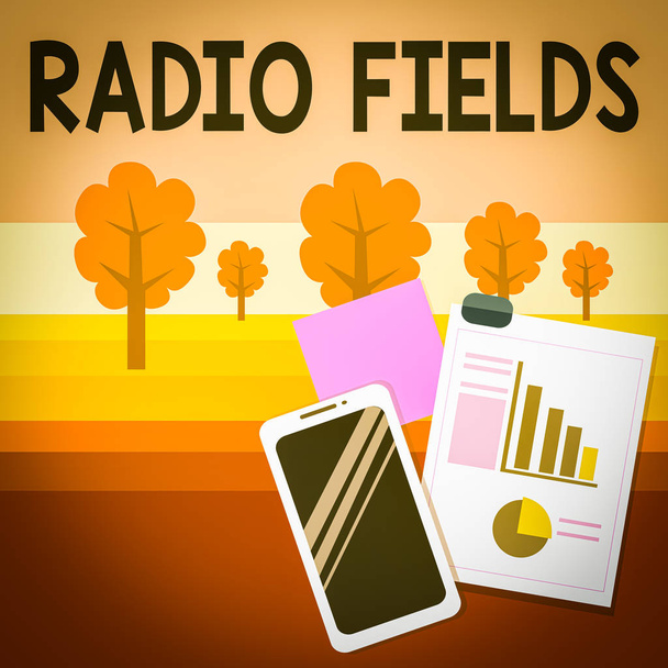 Writing note showing Radio Fields. Business concept for electromagnetic field intensity consisting of an electric Layout Smartphone Sticky Notes with Pie Chart and Bar Graph - Photo, Image