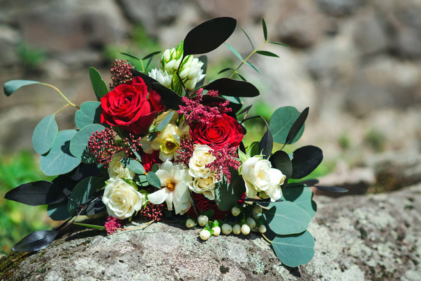 Stylish bouquet with red and white flowers and eucalyptus branches. Unusual wedding bohemian floristic flowers - Foto, Bild