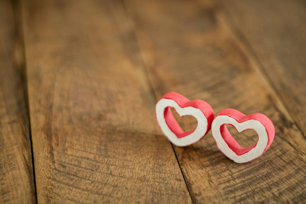 Accessories of decorations valentine's day holiday background concept.Essential item colorful red love couple shape on modern brown paper wallpaper.blank space for mock up creative design word. - 写真・画像