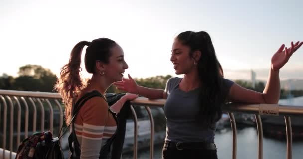 Girlfriends hanging out on bridge at sunset - Felvétel, videó