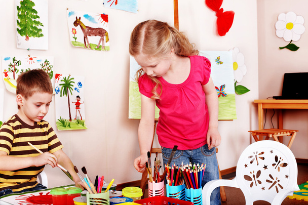 Child draw paints in play room. - Photo, Image