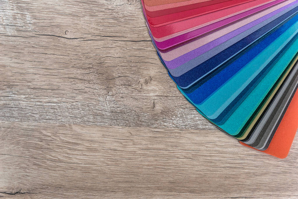Striped colour sampler on wooden desk background - 写真・画像