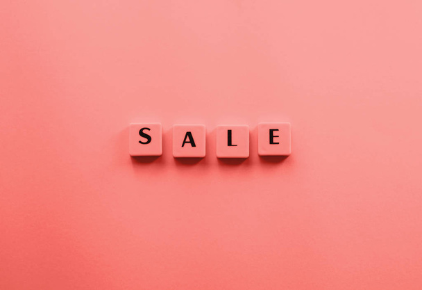 Sale word composed with plastic tiles on coral - Photo, Image