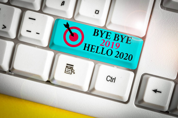Text sign showing Bye Bye 2019 Hello 2020. Business photo showcasing búcsút mond a tavalyi és üdvözlő egy másik jó fehér pc billentyűzet üres jegyzet papír felett fehér háttér kulcs másolási hely - Fotó, kép