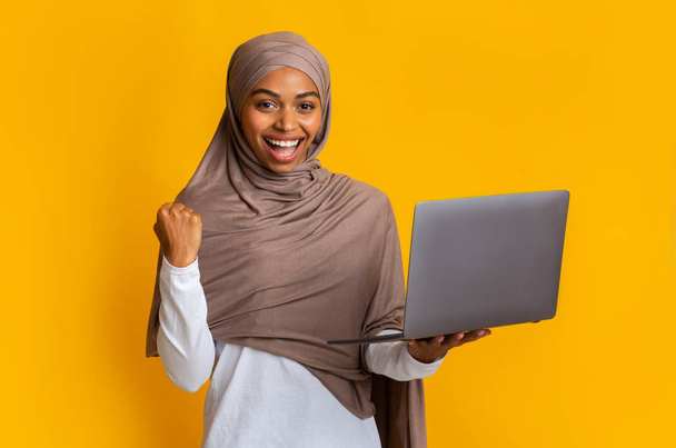 Cheerful Afro Muslim Girl In Headscarf Rejoicing Success With Laptop - Photo, Image