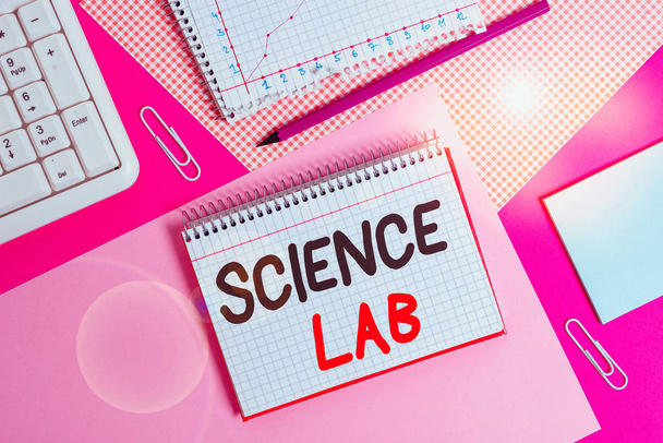 Writing note showing Science Lab. Business concept for special facility where experiments are done and with equipment Writing equipments and computer stuffs placed above colored plain table - 写真・画像