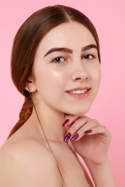 Beautiful young girl touching her perfect skin on pink background. - Φωτογραφία, εικόνα