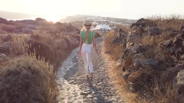 attractive and stylish girl or woman walk on the greek resort oia outdoor - Filmmaterial, Video