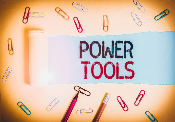 Word writing text Power Tools. Business photo showcasing tool that is actuated by additional power source and mechanism Stationary and torn cardboard placed above a plain pastel table backdrop - Photo, Image