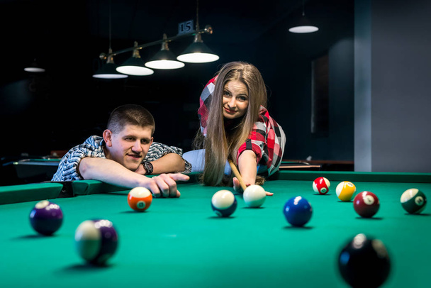 Man pointing ball for shoot, couple playing billiard - Photo, Image