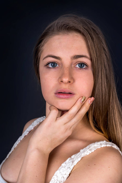 Portrait of blonde woman with hands on her neck - Foto, immagini