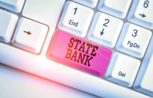 Word writing text State Bank. Business photo showcasing generally a financial institution that is chartered by a state. White pc keyboard with empty note paper above white background key copy space - Photo, Image