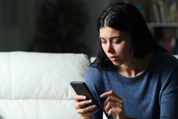 Worried woman checking cell phone text in the night - Photo, Image
