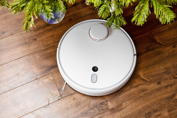 Robotic vacuum cleaner cleans the room from dust and debris, technological progress. - Photo, Image