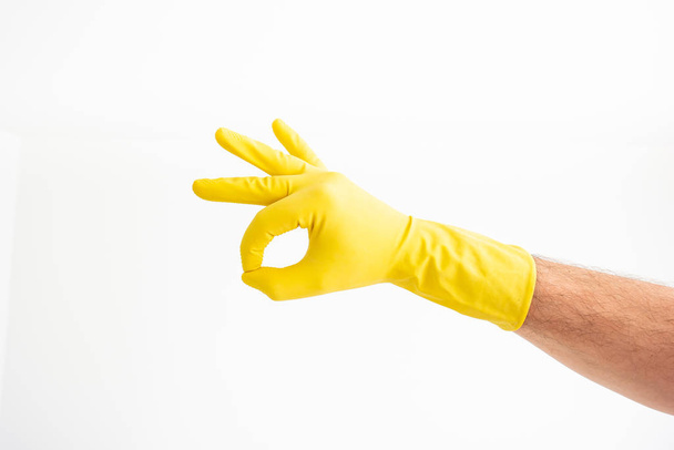 White Caucasian male hand with yellow latex glove showing the OK - Φωτογραφία, εικόνα