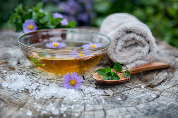 Spa and wellness setting with sea salt, oil essence, flowers and - Photo, Image