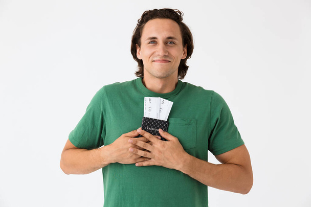 Image of positive brunette man holding passport and travel tickets - Fotoğraf, Görsel