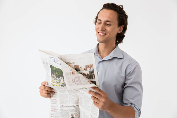 Image closeup of young businessman in office shirt reading newsp - Foto, Imagen