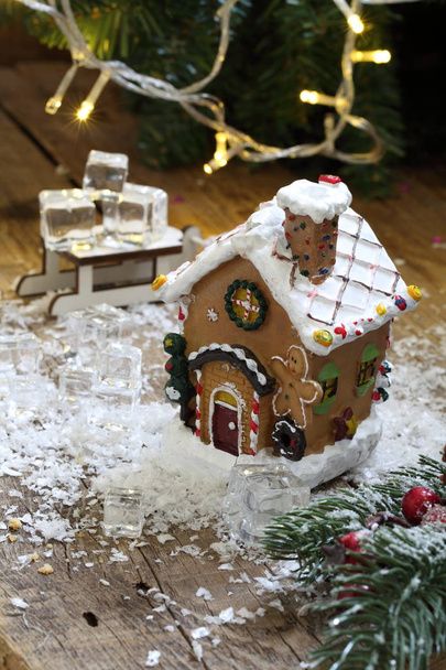 Gingerbread house in the snow against the background of a garland - Fotografie, Obrázek