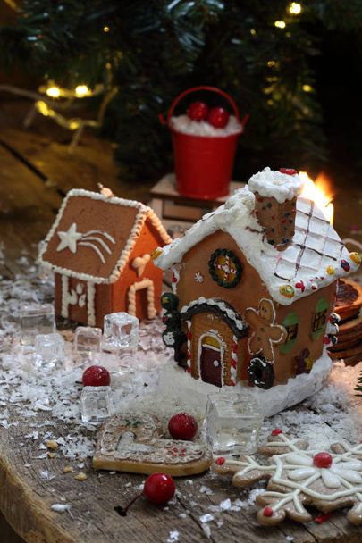 Gingerbread house in the snow against the background of a garland - 写真・画像