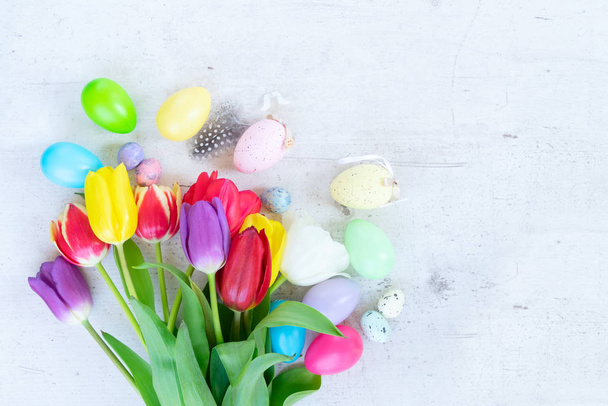 Easter colored eggs with tulips - Fotó, kép