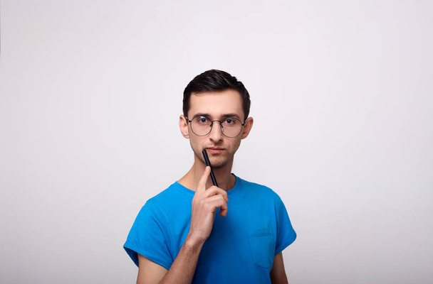 Pensive guy with glasses for learning. - 写真・画像