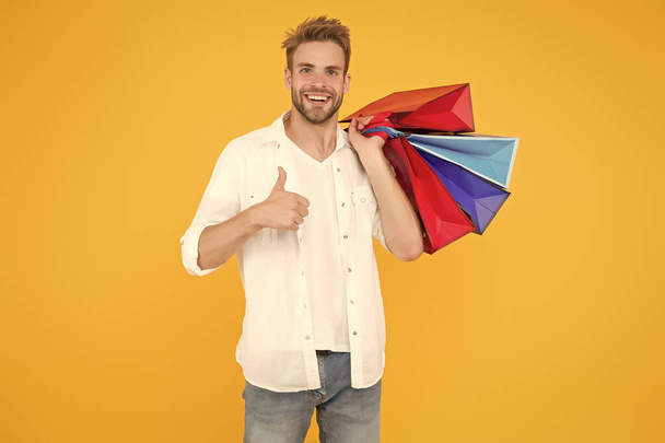 Best price. Cyber monday. Total sale. Positive man enjoying shopping. Happy man with shopping bags. Excited smiling guy doing shopping. Shopping happiness. Nice purchase. Gifts for holidays - Zdjęcie, obraz