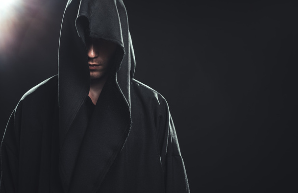 Portrait of man in a black robe - Фото, изображение