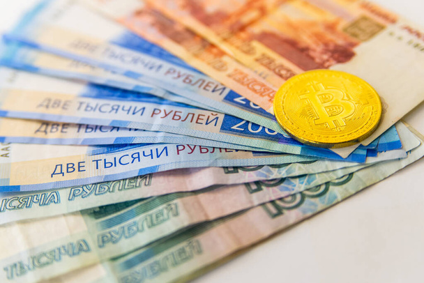 Golden Bitcoins close-up on euro currency background. High resolution photo - Valokuva, kuva