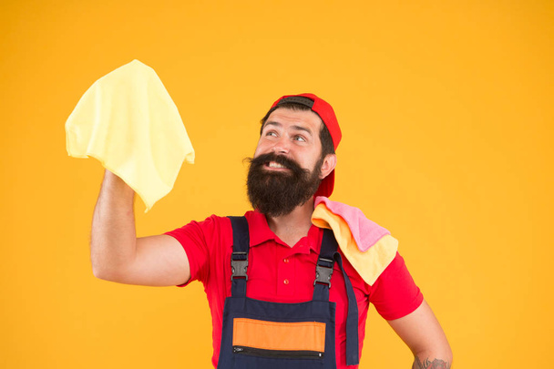 bearded man hold duster microfiber for cleaning. man clean house. housekeeping business. call for cleaning service. male maid household. happy hipster cleaning material in hand. laundering worker - Foto, afbeelding
