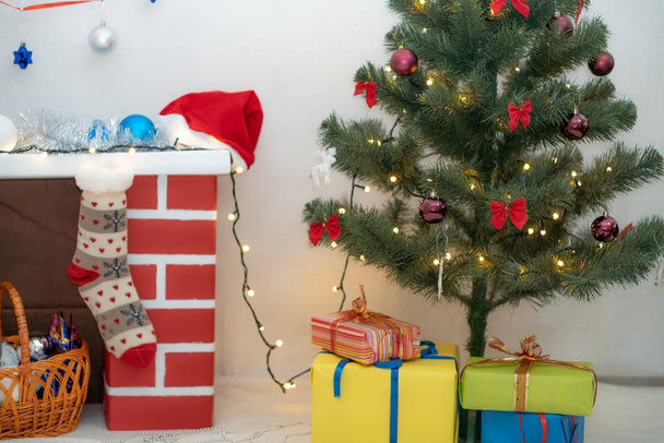 Christmas decoration Christmas tree fireplace and gifts - Фото, зображення
