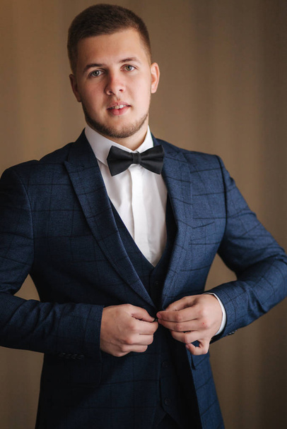 Portrait of handsome young groom in midnight blue sout with bow tie - Fotografie, Obrázek