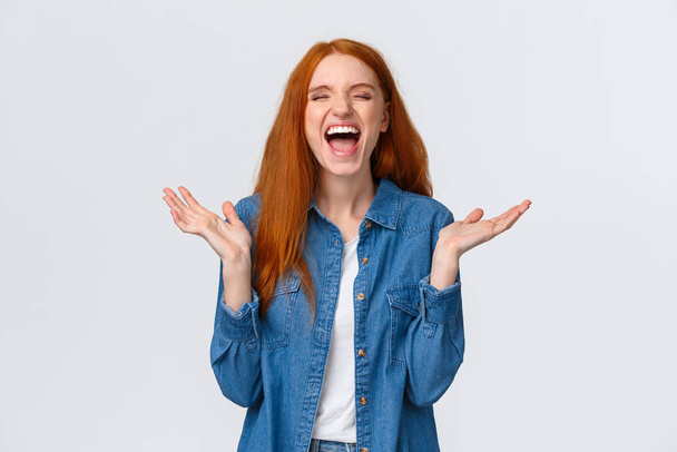 Lol so funny. Amused and carefree pretty redhead female student clap hands, applause with closed eyes as laughing out loud, having fun, hear hilarious joke, standing white background - Foto, immagini